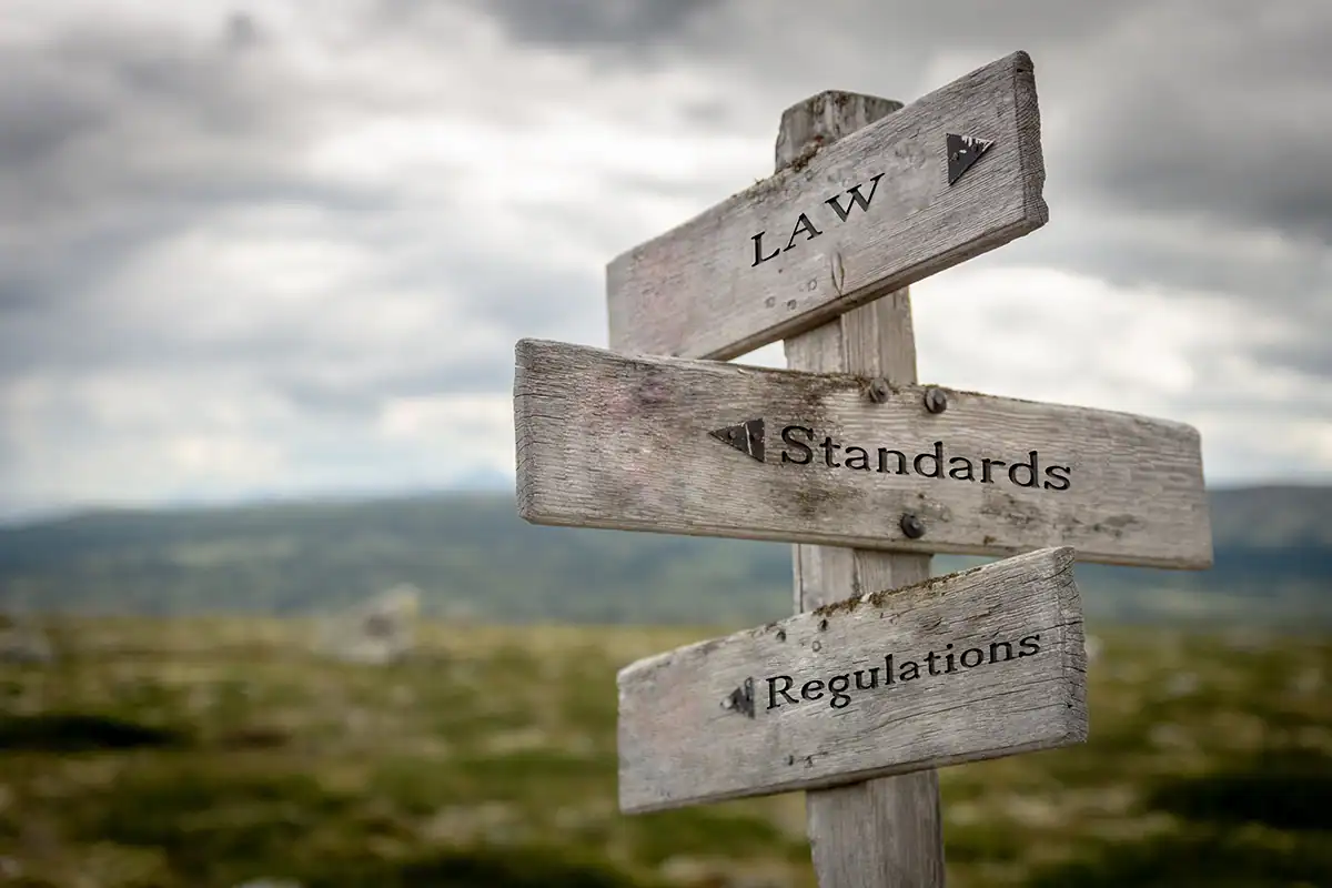 Signpost with cloudy sky and hills in background