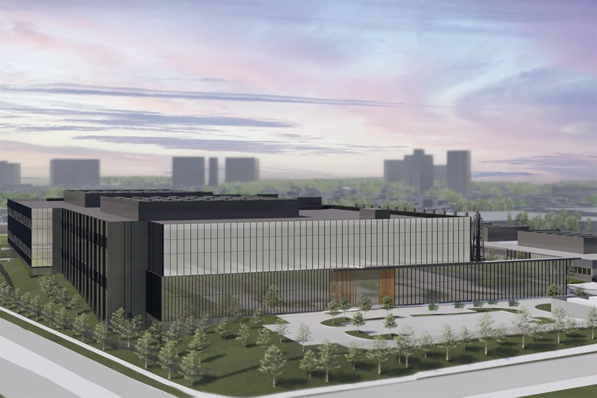 Large lowrise building with city in background
