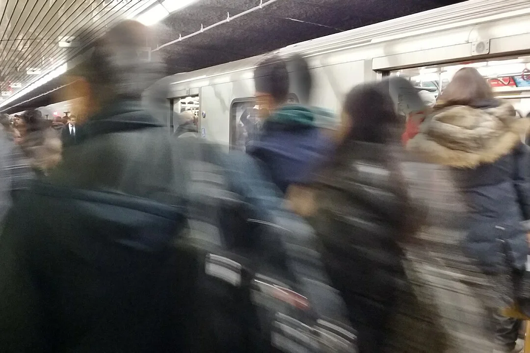 People rushing for a subway car.